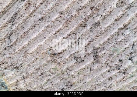 Consistenza in tufo rosa, primo piano su sfondo naturale di roccia vulcanica Foto Stock
