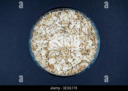 Molti deliziosi fiocchi d'avena sul bancone del mercato della spesa, gustoso cibo biologico composto da fiocchi freschi di avena da vicino, bella consistenza matura di naturale Foto Stock