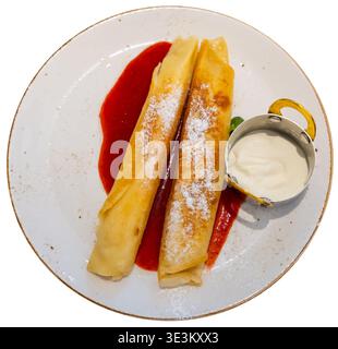 Il dessert nel ristorante è costituito da due pancake arrotolati, ripieni di cagliata Foto Stock