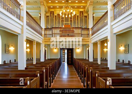 All'interno della chiesa di Domkirkjan, le panchine sono vuote. La luce entra dalle finestre e l'organo è visibile sopra. Foto Stock
