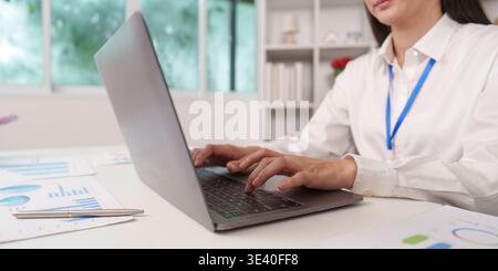 Primo piano della digitazione del contabile su un notebook in ufficio Foto Stock