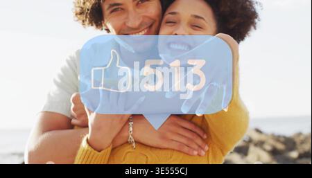 Abbracciando la coppia appoggiata sulla costa rocciosa, indossando un maglione senape, bolla blu 513 Foto Stock