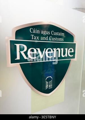 Cartello delle imposte sulle entrate e delle dogane presso l'aeroporto di Cork, Irlanda, che mostra il marchio bilingue irlandese e inglese per l'autorità fiscale e doganale dello Stato. Foto Stock