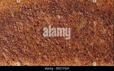 Cibo, immagine ad alta risoluzione che cattura i dettagli del pane tostato con una superficie croccante Foto Stock