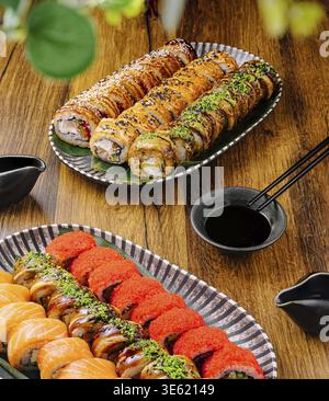 Cibo, panini di sushi con vari condimenti sono esposti artisticamente su piatti eleganti. Salse e bacchette accompagnano il vivace assortimento, e. Foto Stock