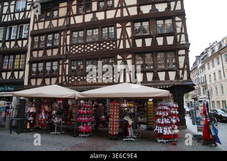 Strasburgo, Francia - 21 settembre 2018: Edificio a graticcio con un negozio di souvenir e mostre colorate a Strasburgo Foto Stock