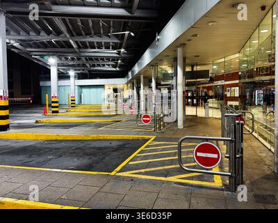 Londra, Regno Unito - 3 febbraio 2026: Baie vuote illuminate per i trasporti, barriere pedonali e nessun cartello di ingresso in un tranquillo terminal di Londra. Foto Stock