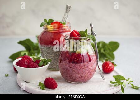 Budini di semi di chia con frutti di bosco e frutta per colazione Foto Stock