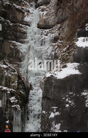 Una spettacolare cascata ghiacciata con enormi ghiaccioli aggrappati a una ripida parete rocciosa nella Valle Echerntal vicino a Hallstatt, Austria, durante l'inverno. Foto Stock