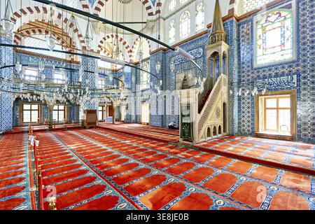 L'interno della Moschea Rustem Pasha mostra piastrelle colorate e spazi vuoti di preghiera. La luce entra dalle finestre, proiettando ombre sul pavimento Foto Stock