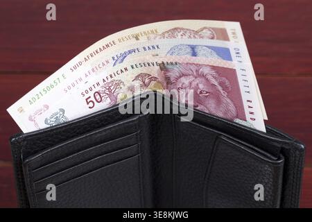 Old South African soldi- Rand nel portafoglio nero Foto Stock