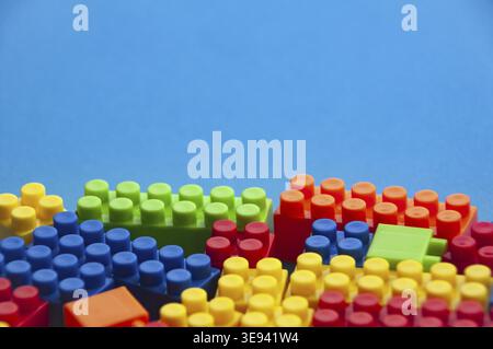 Blocchi di plastica su sfondo blu. Spazio di copia Foto Stock