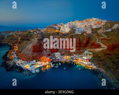 La cittadina di Oia sull isola di Santorini, Grecia. Tradizionale e famose case e chiese con le cupole blu sulla Caldera, il Mare Egeo Foto Stock