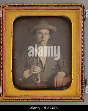 Untitled (Portrait of a Man Smoking a Pipe) di Unknown Maker, 1853, uomo in cappello da cowboy e camicia da lavoro con pipa lunga, sguardo diretto, ritratto in studio a metà lunghezza Foto Stock