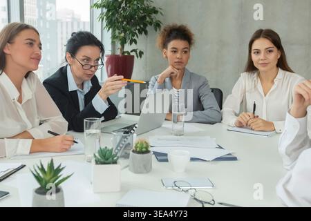 Donne d'affari che hanno briefing in ufficio e condividere idee Foto Stock