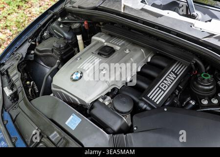 Zurigo, Svizzera, 17 aprile 2026. Vista dall'alto del vano motore a benzina in linea da 3,0 litri BMW N52B30 color argento in un veicolo metallico blu Foto Stock