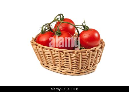 Cestino di vimini con pomodori cespugli (lat: Solanum lycopersicum) su sfondo bianco studio con ombra di contatto. Foto Stock