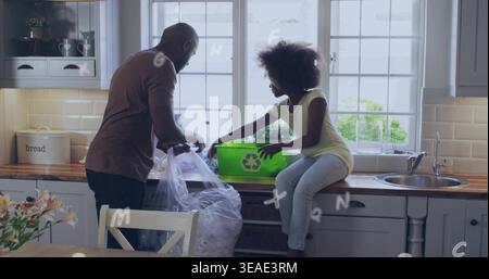 Smistamento di padre e figlia che collocano prodotti riciclabili al banco della cucina, con un bidone verde brillante Foto Stock