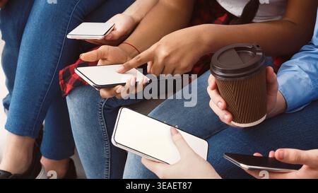 Ragazza che punta il dito sullo schermo del telefono, mostrando la nuova app Foto Stock