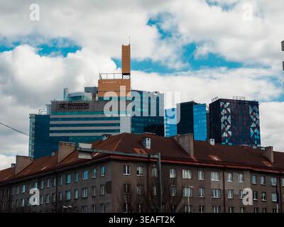 I moderni grattacieli di vetro che includono il Radisson Collection hotel si innalzano dietro l'edificio di appartamenti di epoca sovietica nel centro di Tallinn, in primavera Foto Stock