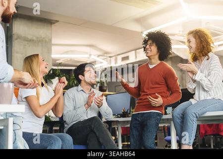 Il team Creative godendo la comunicazione in ufficio moderno Foto Stock