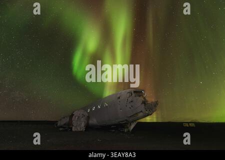 Aurora boreale sul relitto aereo a Vik, Islanda Foto Stock