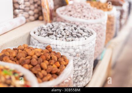 Albicocche secche e semi esposti in sacchetti al bazar Siab di Samarcanda. Tradizionale bancarello da mercato con frutta secca e frutta secca, ideale per i viaggi e. Foto Stock
