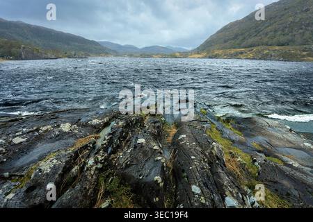 Il fiume Owengarriff incontra il lago Muckross con l'antico e ghiacciato primo piano della roccia di Old Red Sandstone nel Killarney National Park, nella contea di Kerry, Irlanda Foto Stock