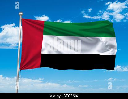 La bandiera nazionale degli Emirati Arabi Uniti che sventola contro un cielo azzurro. Foto Stock