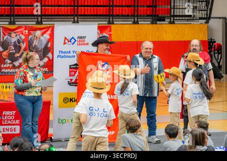 Texas, Stati Uniti, 07 marzo 2026 - Un gruppo di bambini sorridenti con camicie bianche abbinate e cappelli da cowboy festeggiano con gli adulti durante un colorato awar Foto Stock