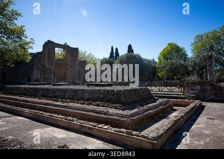 Scavi di fondazioni romane e mura in mattoni in rovina con apertura ad arco a Villa Adriana, Tivoli, Lazio, Italia Foto Stock