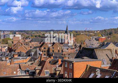 Guardando a nord-est sulla città belga di Mons, girato dal Belfry di Mons (Beffroi de Mons) con la torre dell'orologio fuori centro della Chiesa di Santa Elisabetta Foto Stock