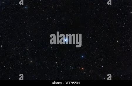 Nebulosa blu celeste riflessa luminosa in mezzo a un ricco campo di stelle lontane attraverso il cosmo. Foto Stock