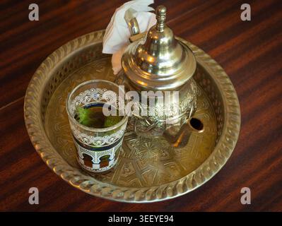 Tè marocchino alla menta in teiera e bicchiere, tradizionale bevanda araba dal Marocco Foto Stock