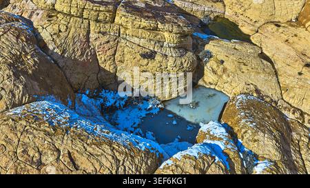 Piscine aeree di acqua ghiacciata e neve sulle formazioni arenarie Red Rock Nevada Foto Stock