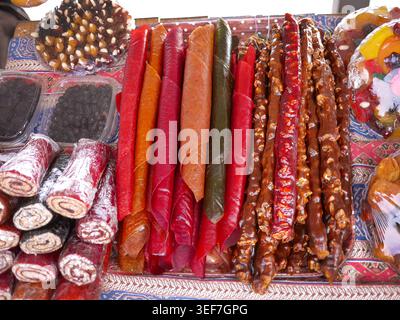 Foto ad alto angolo di vivace bancarelle di Street food in Georgia con una varietà di autentici dolci locali. L'esposizione include la nota pelle di frutta arrotolata Foto Stock