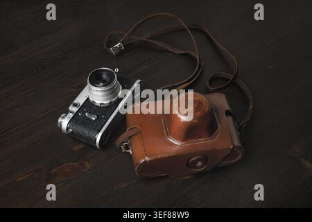 Fotocamera retrò su sfondo tavolo in legno Foto Stock