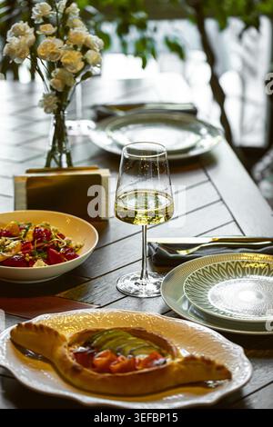 Elegante tavolo del ristorante con bicchiere di vino Foto Stock