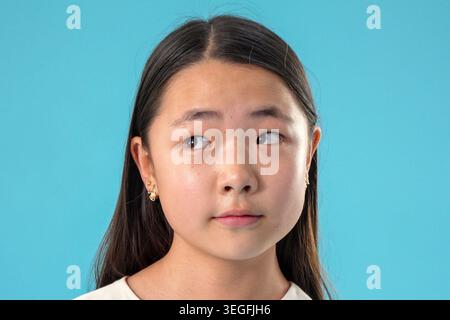 Primo piano ritratto di una giovane donna asiatica delusa che guarda Foto Stock