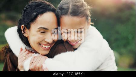 Sorridi, natura e bambino che abbracciano la madre nel parco per legare, amare e andare in vacanza insieme con la famiglia. Felice, all'aperto e ragazza che abbraccia mamma per Foto Stock