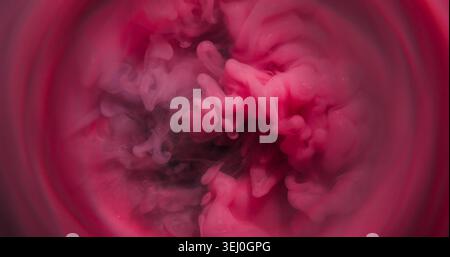 Miscela fluida, nebbia vorticosa defocalizzata. Vernice rosa sfocata di colore porpora. Texture glitter fumata che si diffonde su sfondo artistico rotondo astratto. Foto Stock