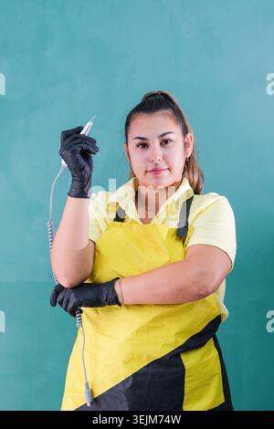 Manicure master in guanti neri con smerigliatrice per unghie Foto Stock