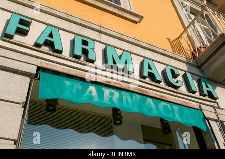 Primo piano di un cartello minimalista della Farmacia Italiana (farmacia) su una facciata di un edificio urbano. Assistenza sanitaria, servizi medici e farmacia Foto Stock