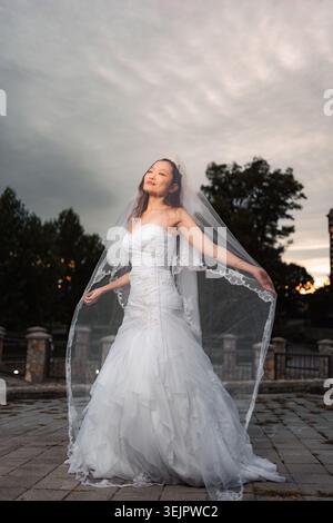 Sposa cinese che indossa abiti da sposa e velo per preparare il matrimonio Foto Stock