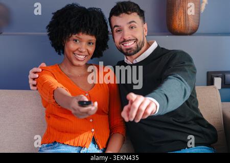 Rilassati seduto sul divano e guarda la televisione a casa Foto Stock