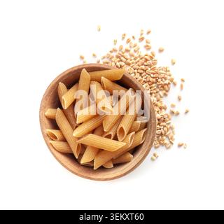 Pasta integrale cruda isolata, penne di grano integrale in ciotola, tagliatelle di grano intero secche, farro crudo maccheroni, cibo sano italiano, farina biologica, passato di grano intero Foto Stock