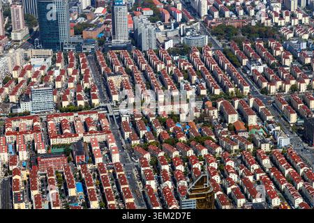 Vista aerea di bassi edifici residenziali densamente popolati con tetti di tegole rosse a Shanghai, Cina Foto Stock