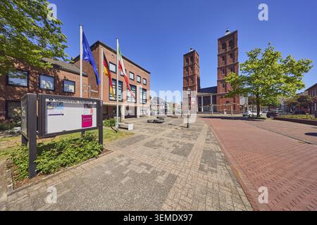 Municipio, amministrazione comunale, bacheca, chiesa di San Lorenzo, doppia torre, edificio commerciale, edificio in mattoni, architettura moderna, flagpo Foto Stock