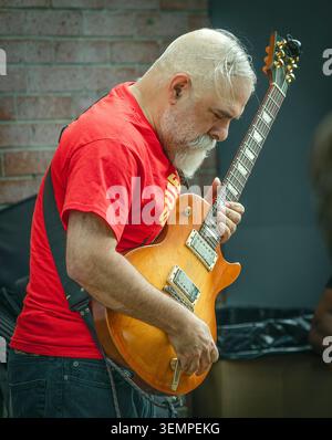 Uomo anziano con barba bianca che suona la chitarra elettrica Foto Stock