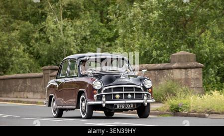 Stony Stratford, Bucks, Regno Unito - 7 giugno 2026: 1957 Morris Oxford auto d'epoca che guida su una strada britannica Foto Stock